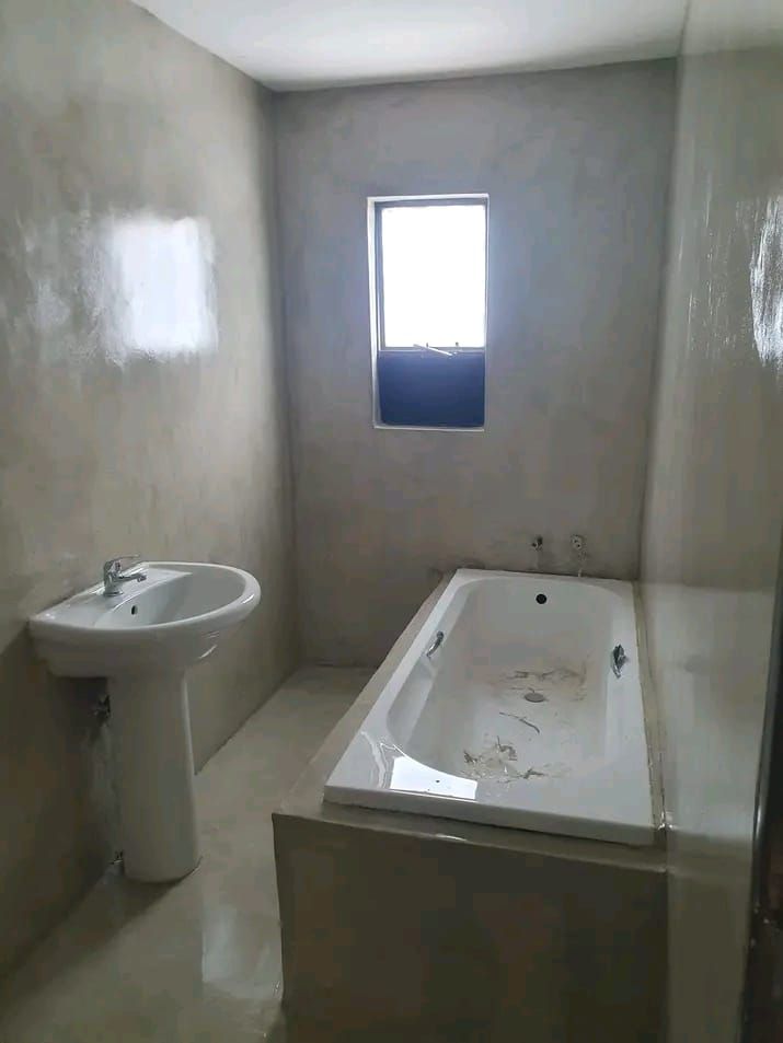 Seamless stucco finish applied to a bathroom interior