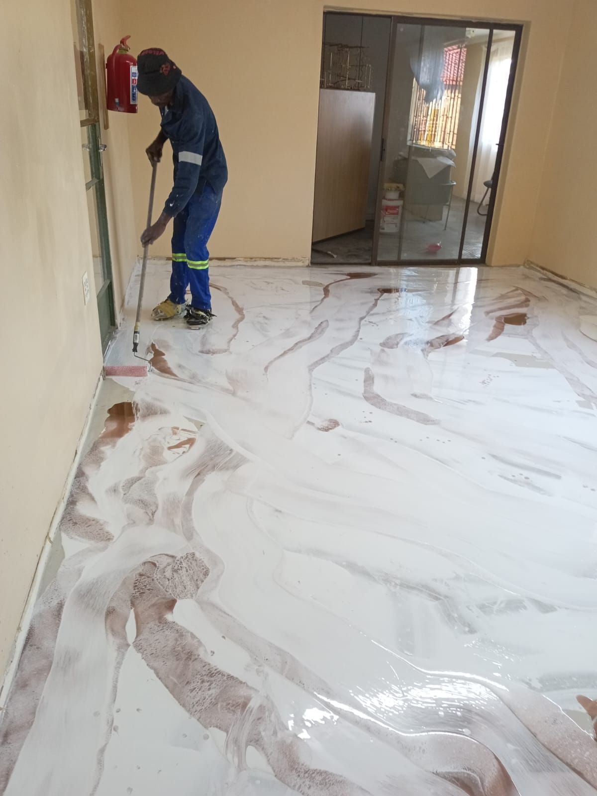 Pearl marble epoxy floor being finished in a Pretoria home