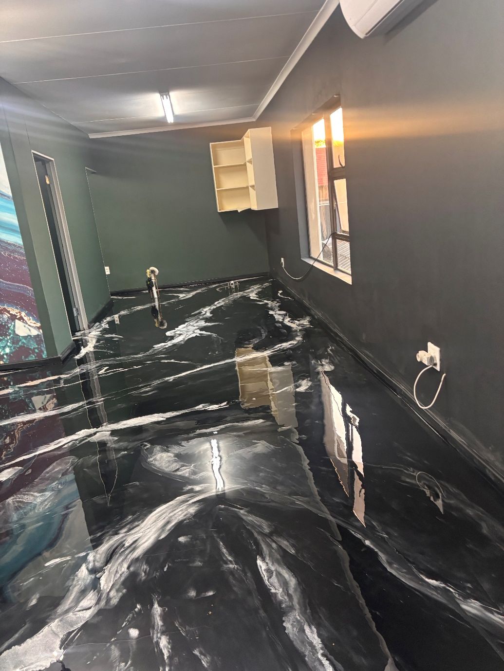 Charcoal metallic epoxy floor with silver veining in a residential interior